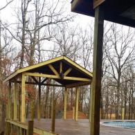 Wooden pool deck with covered area