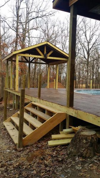 Wooden pool deck with covered area